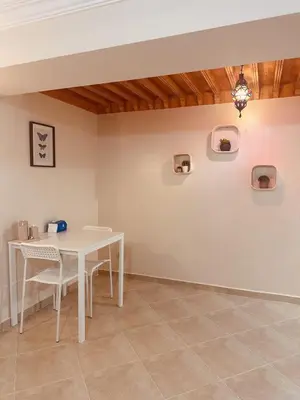 a dining room with a white table and chairs at Blue and sun Majorelle comfort and spacious in Marrakech