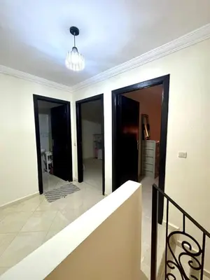 a hallway with doors and a staircase in a house at Gouarial in Marrakech
