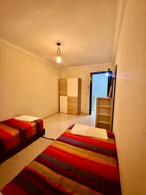 a room with two beds and a ladder in it at Gouarial in Marrakech