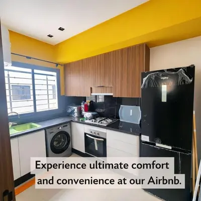 a kitchen with a black and white appliance in it at New comfy appartement-centre -Menara-Gueliz-aero in Marrakech