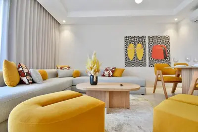 a living room with a couch and a table at Marrakech Luxury 2BR Pool View and Terrace for Remote Work in Marrakech