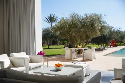 a living room with white furniture and a pool at Elegant 3-BR Villa with breakfast included in Marrakech