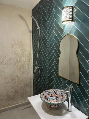 a bathroom with a sink and a mirror at Riad Lalla Nadia in Marrakech