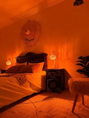 a bedroom with a bed and a lamp on a wall at Charming Bohemian hideaway in Marrakech in Marrakech