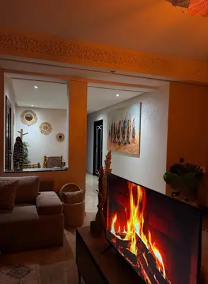 a fireplace in a living room with a fire place at Charming Bohemian hideaway in Marrakech in Marrakech
