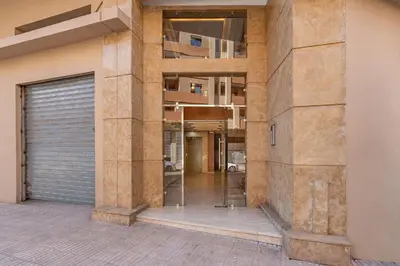 a building with a garage door and a building at F2 Cozy and Swimming pool in Marrakech