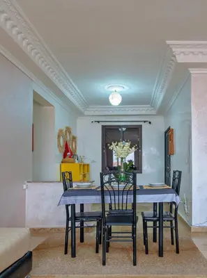 a dining room with a table and chairs at Dar Joud in Marrakech