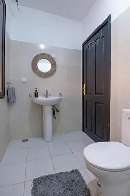 a bathroom with a sink and a toilet and a mirror at Dar Joud in Marrakech