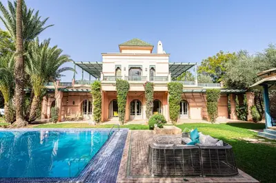 a large house with a swimming pool in front of it at Villa Soleil Private Pool & Garden in Marrakech
