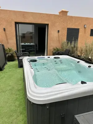 a hot tub in the backyard of a house at Exceptional Villa Noria Golf in Marrakech