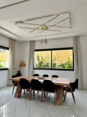 a dining room with a wooden table and chairs at Exceptional Villa Noria Golf in Marrakech