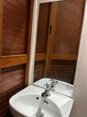 a white sink in a bathroom with a mirror at cozy studio in Kennaria, 1 min from Jemaa el-Fnaa in Marrakech