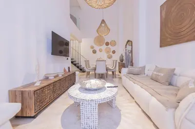 a living room with a couch and a table at Sublime 3-bedroom duplex with pool in Marrakech