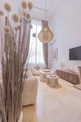 a living room with a couch and a chandelier at Sublime 3-bedroom duplex with pool in Marrakech