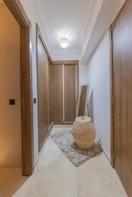 a hallway with a large vase sitting on the floor at Sublime 3-bedroom duplex with pool in Marrakech