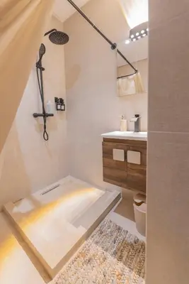 a bathroom with a shower with a toilet and a sink at Sublime 3-bedroom duplex with pool in Marrakech
