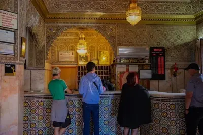a group of people standing at a bar in a restaurant at GRAND HOTEL TAZi in Marrakech