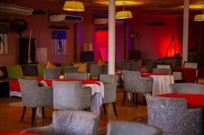 a dining room with red and green tables and chairs at GRAND HOTEL TAZi in Marrakech