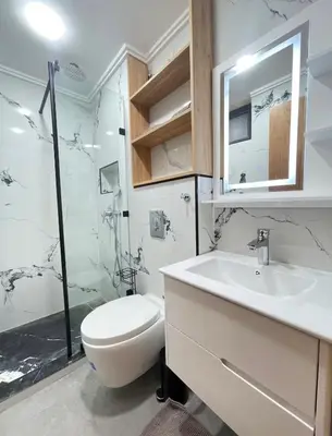 a bathroom with a toilet and a sink and a shower at Comfort Suites Marrakech in Marrakech