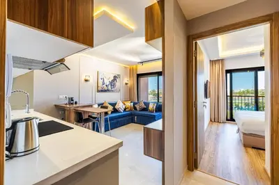 a kitchen and living room with a blue couch at Noria Modern & Cozy Piscine in Marrakech