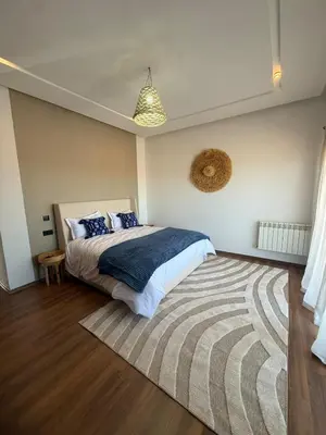 a bedroom with a large bed and a rug at Exceptional Villa Private Pool and Breakfast in Marrakech