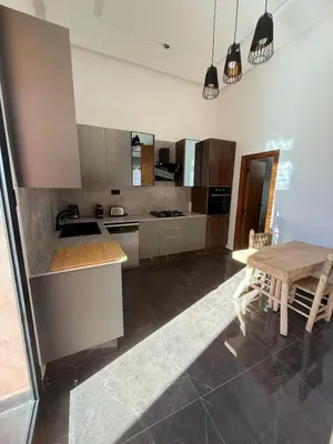 a kitchen with a wooden table and a dining room at Exceptional Villa Private Pool and Breakfast in Marrakech