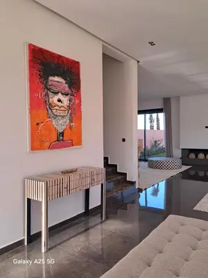 a living room with a painting on the wall at Exceptional Villa Private Pool and Breakfast in Marrakech
