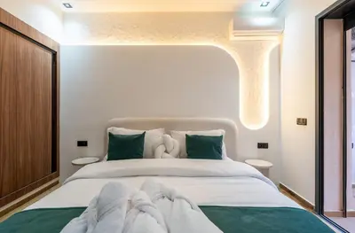 a bedroom with a large white bed with green pillows at New! Maya House - Pool - Netflix - Gueliz in Marrakech