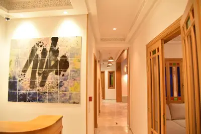 a hallway with a painting on the wall at Riad House of Calligraphy Marrakech in Marrakech