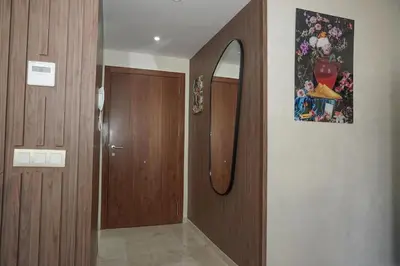 a bathroom with a wooden door and a mirror at Mamounia loft by M&I in Marrakech