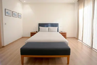 a bedroom with a large bed in a room at The Maison Épure - Marrakesh - Prestigia in Marrakech