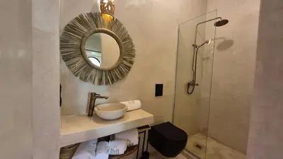a bathroom with a sink and a mirror and a shower at Riad Casa Léa - Palais Bahia - Bassin & Pt Déj in Marrakech