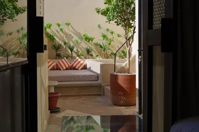a living room with a couch and potted plants at Riad Casa Léa - Palais Bahia - Bassin & Pt Déj in Marrakech