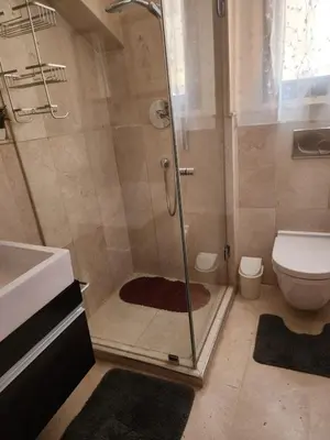a bathroom with a shower with a toilet and a sink at Le Cosy Carré Éden - Hypercentre Gueliz in Marrakech
