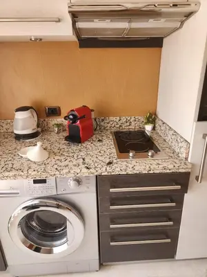 a kitchen with a washing machine on a counter at Le Cosy Carré Éden - Hypercentre Gueliz in Marrakech