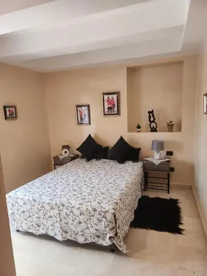 a bedroom with a large bed and two tables at Le Cosy Carré Éden - Hypercentre Gueliz in Marrakech