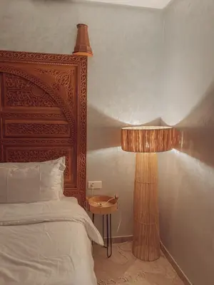 a bedroom with a bed and a lamp next to it at Central Station Cosy Studio in Marrakech