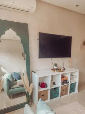a living room with a tv on a wall at Central Station Cosy Studio in Marrakech