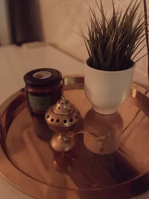 a glass table with a plant and a vase on it at Central Station Cosy Studio in Marrakech
