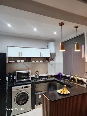 a kitchen with a plate of bananas on a counter at Chic Urban Retreat Bright Apartment in Targa in Marrakech