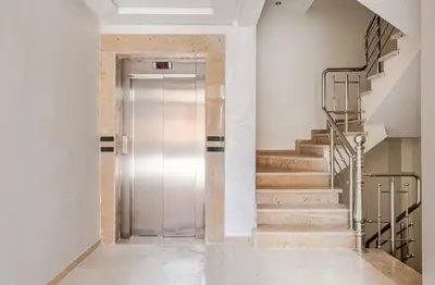 a hallway with a metal door and stairs at Rental unit in Marrakech in Marrakech