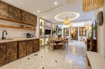 a kitchen and dining room with a table and chairs at Riad Tigmmi - Exclusive - Pool - Free BF - 10 pax in Marrakech