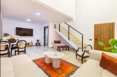 a living room with a white couch and a table at Modern Oasis in Heart of Guéliz Pool Balcony in Marrakech
