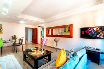 a living room with a blue couch and a table at Menara gardens in Marrakech