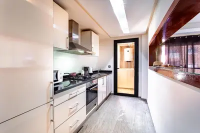 a kitchen with white cabinets and a stove at Menara gardens in Marrakech