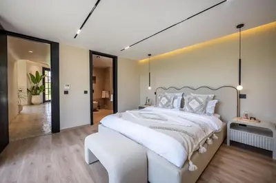 a large white bedroom with a large white bed at MIKESTAY Domaine ATIKA in Segraga