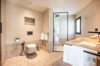 a bathroom with a tub and a toilet and a shower at MIKESTAY Domaine ATIKA in Segraga