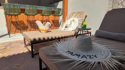a hat sitting on a table in a patio at Riad Tamazy in Marrakech