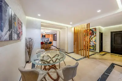 a dining room with a glass table and chairs at Bright & Airy Modern Flat in heart of Marrakech in Marrakech