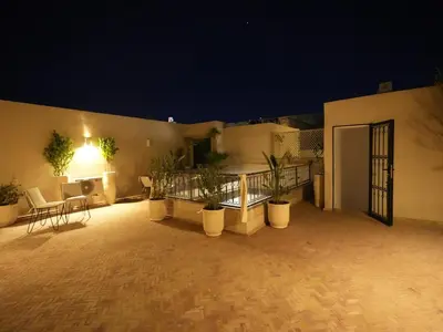 a patio with potted plants in front of a building at Riad privatif Les Tamaris in Marrakech